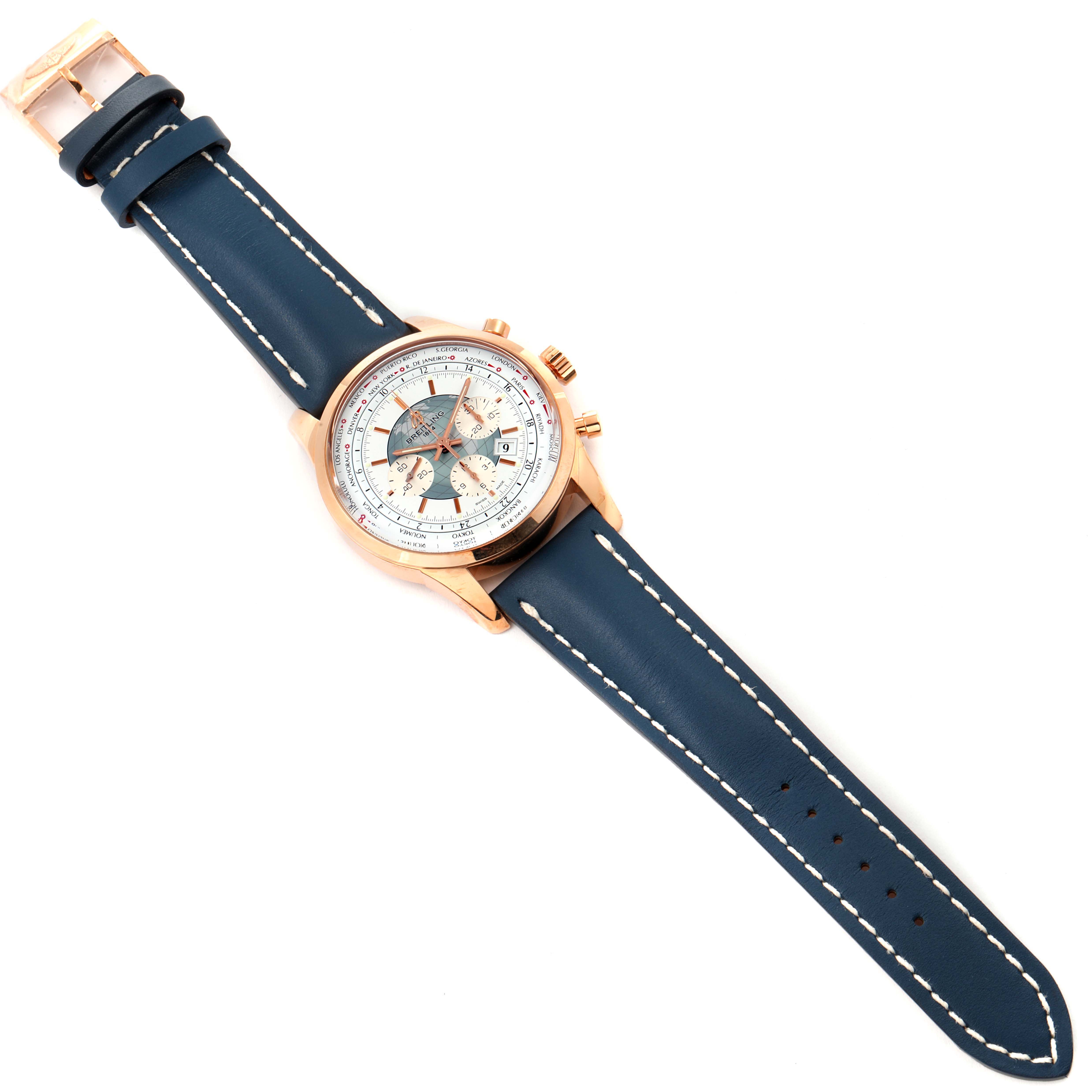 The image shows a top-down view of the Breitling Transocean RB0510U4-BB63BKLD Men's Rose Gold White Dial RB0510U4-BB63BKLD Men's Rose Gold White Dial watch with a blue leather strap and a rose gold case.