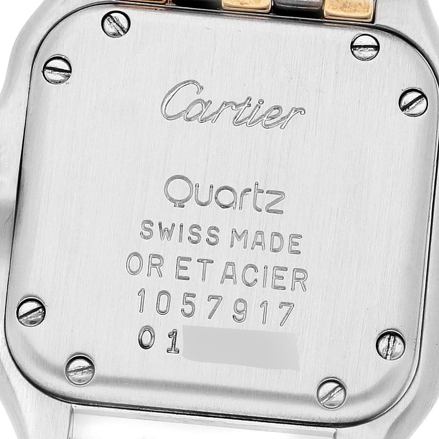 The image shows the back case of the Cartier Panthere W25029B6 Women's Steel and Gold (two tone) Silver Dial W25029B6 Women's Steel and Gold (two tone) Silver Dial model watch, highlighting the inscription and screws.