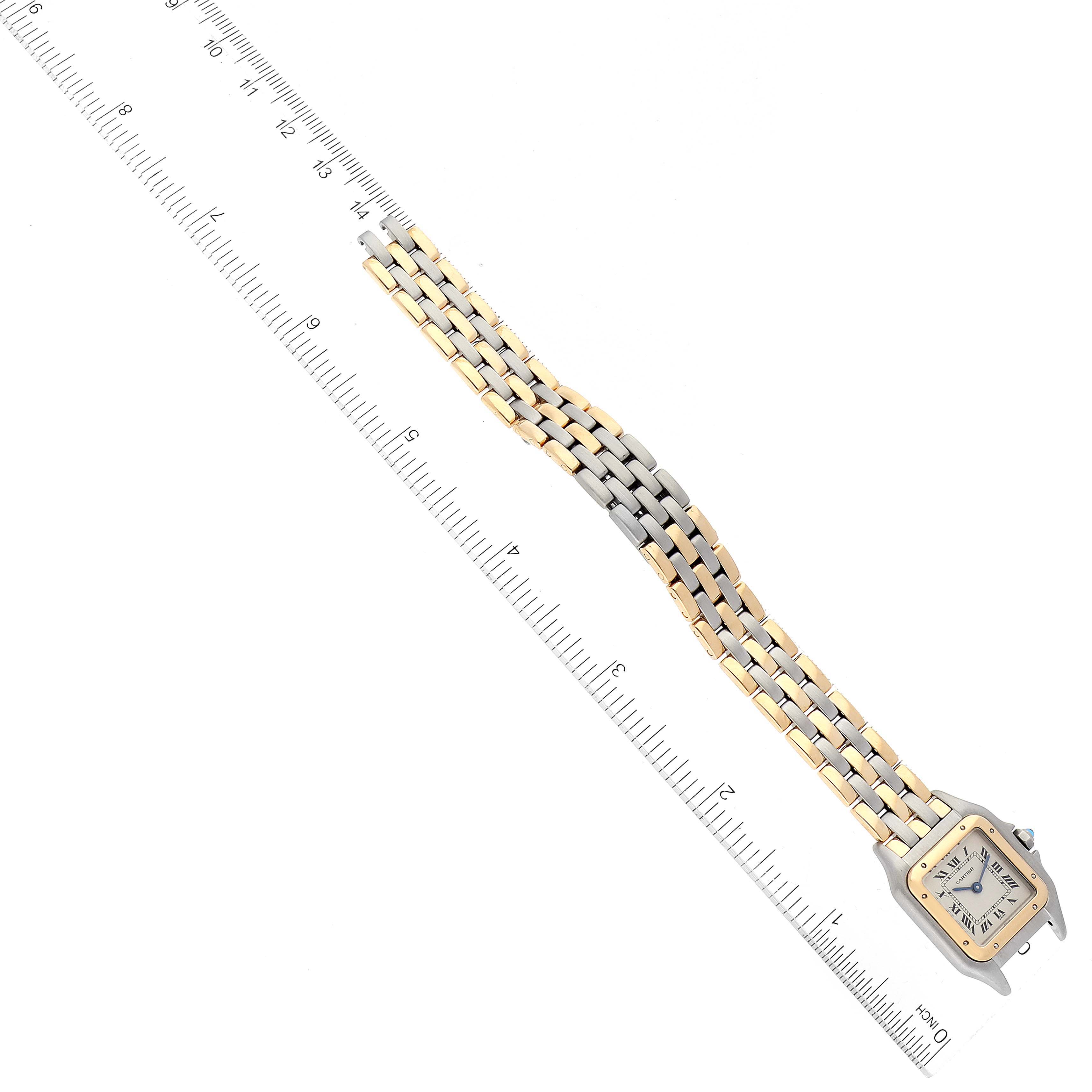 The Cartier Panthere W25029B6 Women's Steel and Gold (two tone) Silver Dial W25029B6 Women's Steel and Gold (two tone) Silver Dial watch is shown from a top-down angle, highlighting its face and bracelet against a ruler for scale.