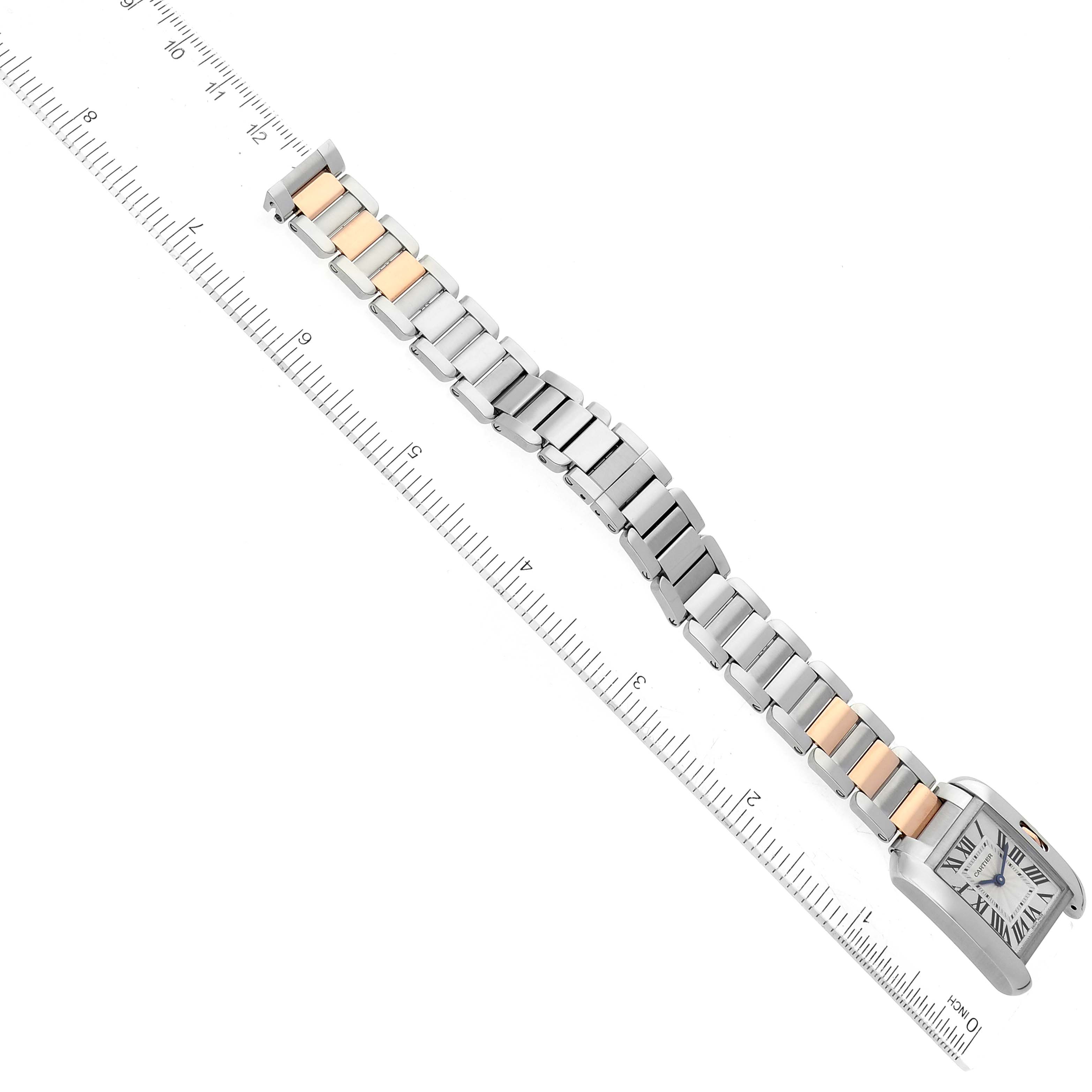 The image shows a top-down view of the Cartier Tank Anglaise W5310036 Women's Steel and Gold (two tone) Silver Dial W5310036 Women's Steel and Gold (two tone) Silver Dial watch, highlighting the face and full length of the bracelet beside a ruler.
