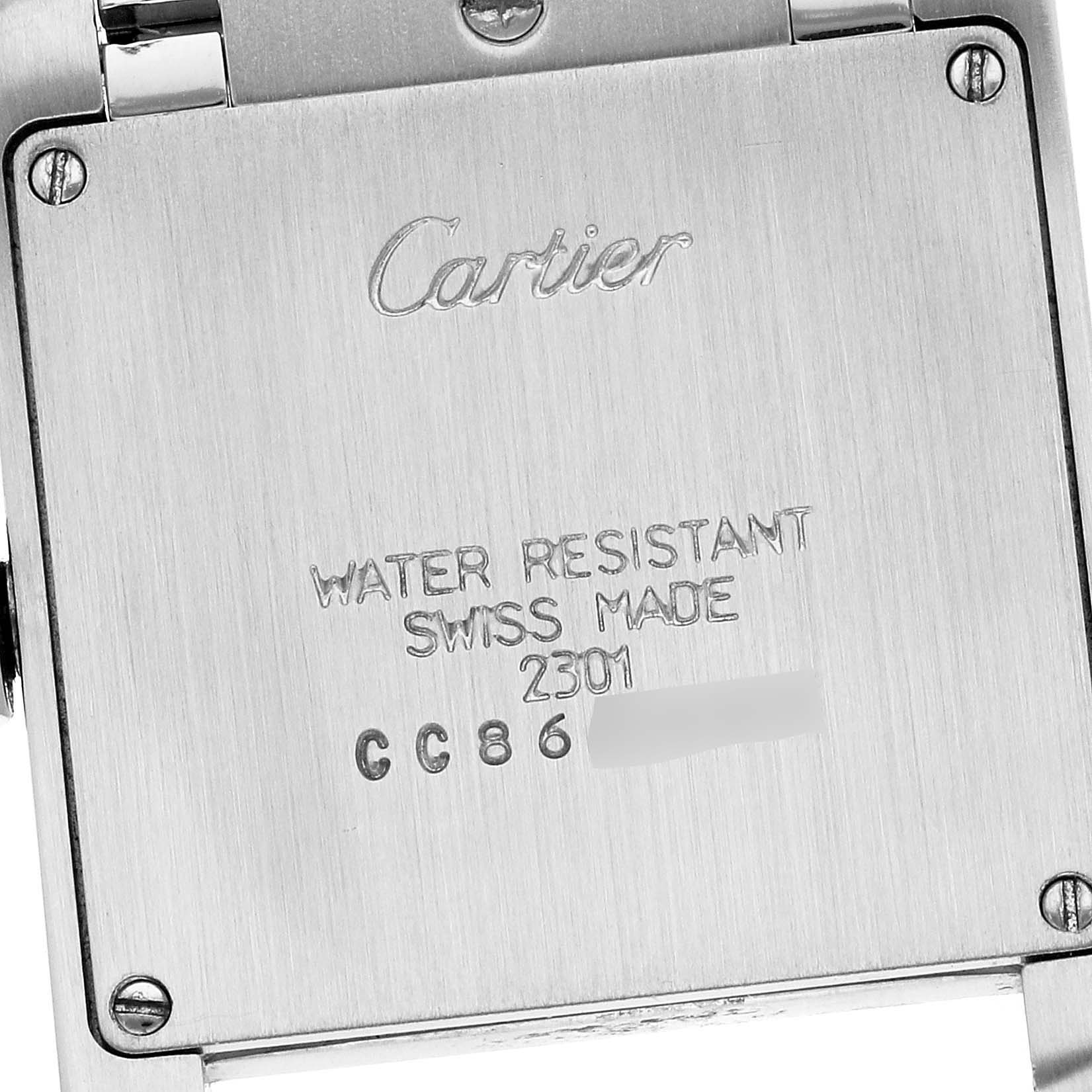 This image shows the back case of a Cartier Tank Francaise WSTA0005 Women
s Stainless Steel Silver Dial WSTA0005 Women
s Stainless Steel Silver Dial watch, highlighting its inscriptions and screws.