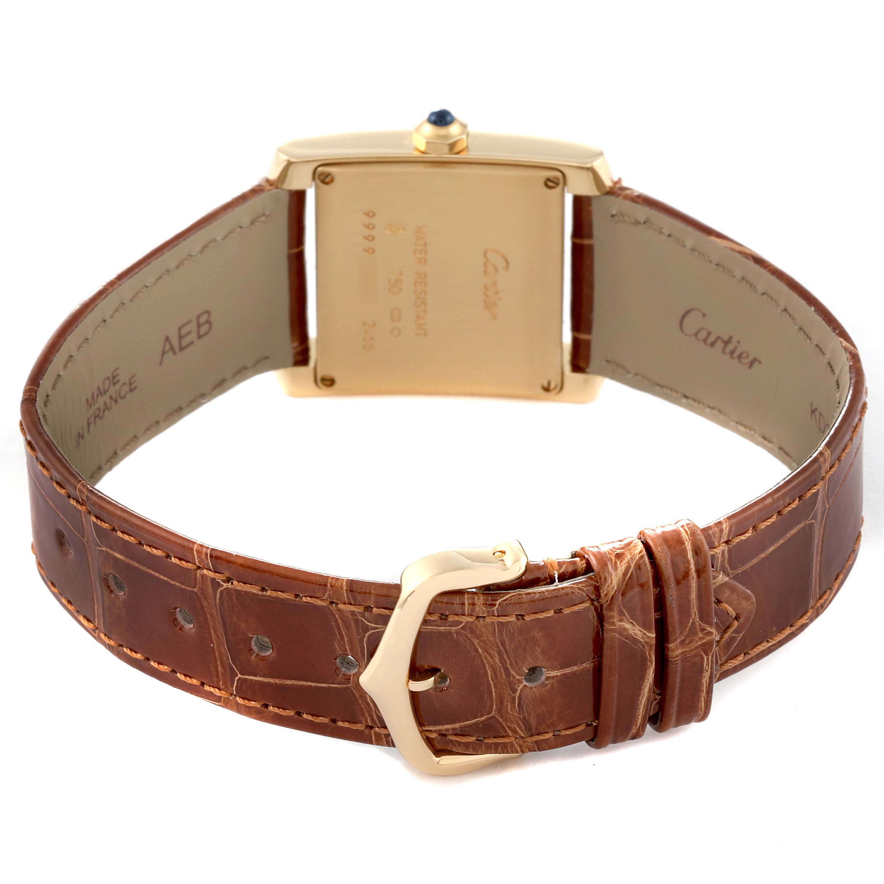 The image shows the back view of a Cartier Tank Française watch, highlighting its case back, brown leather strap, and buckle.