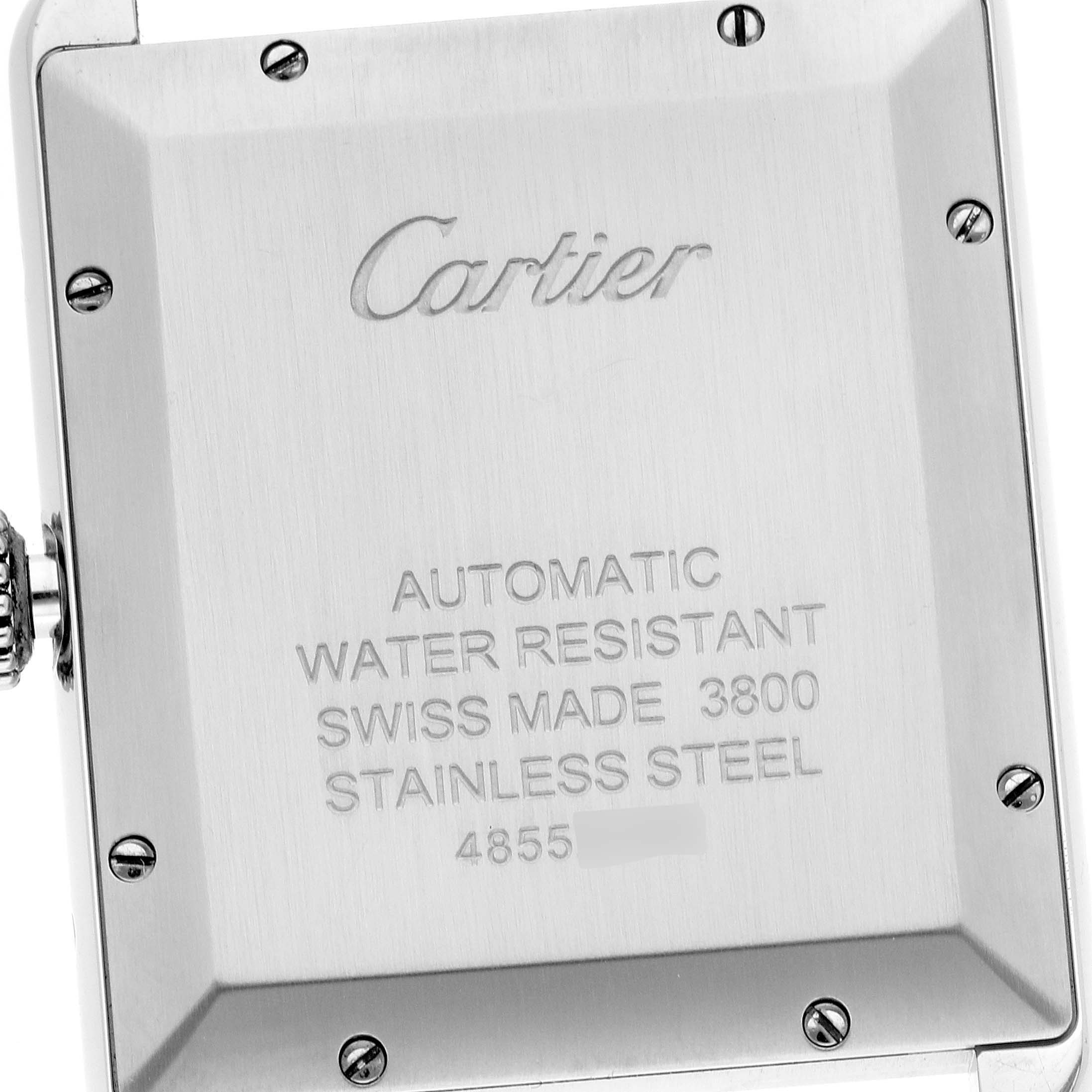 The image shows the back of a Tank Solo watch by Cartier, highlighting its automatic mechanism and stainless steel case.