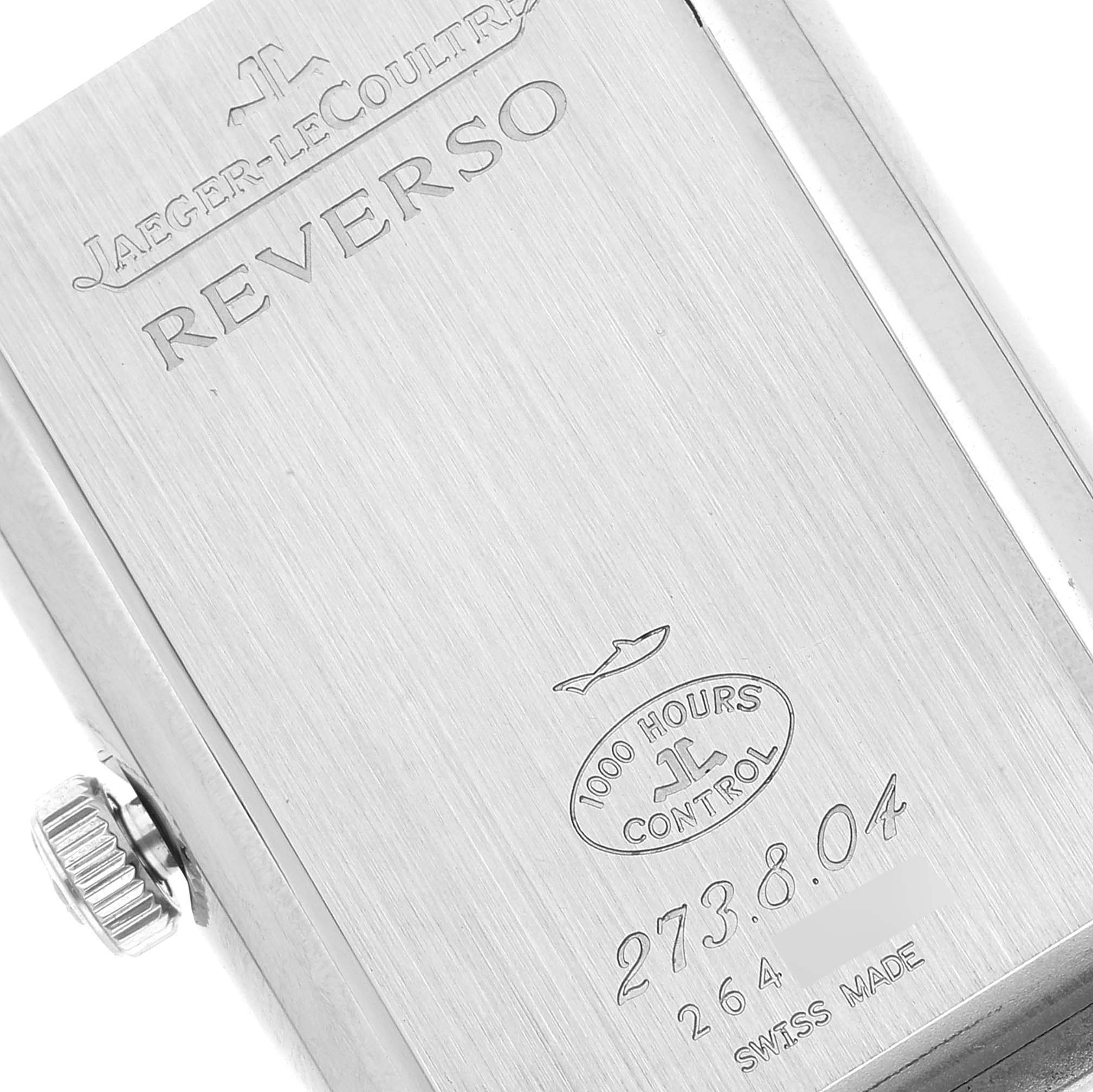 The image shows the engraved case back of a Jaeger-LeCoultre Reverso watch from a close-up angle.