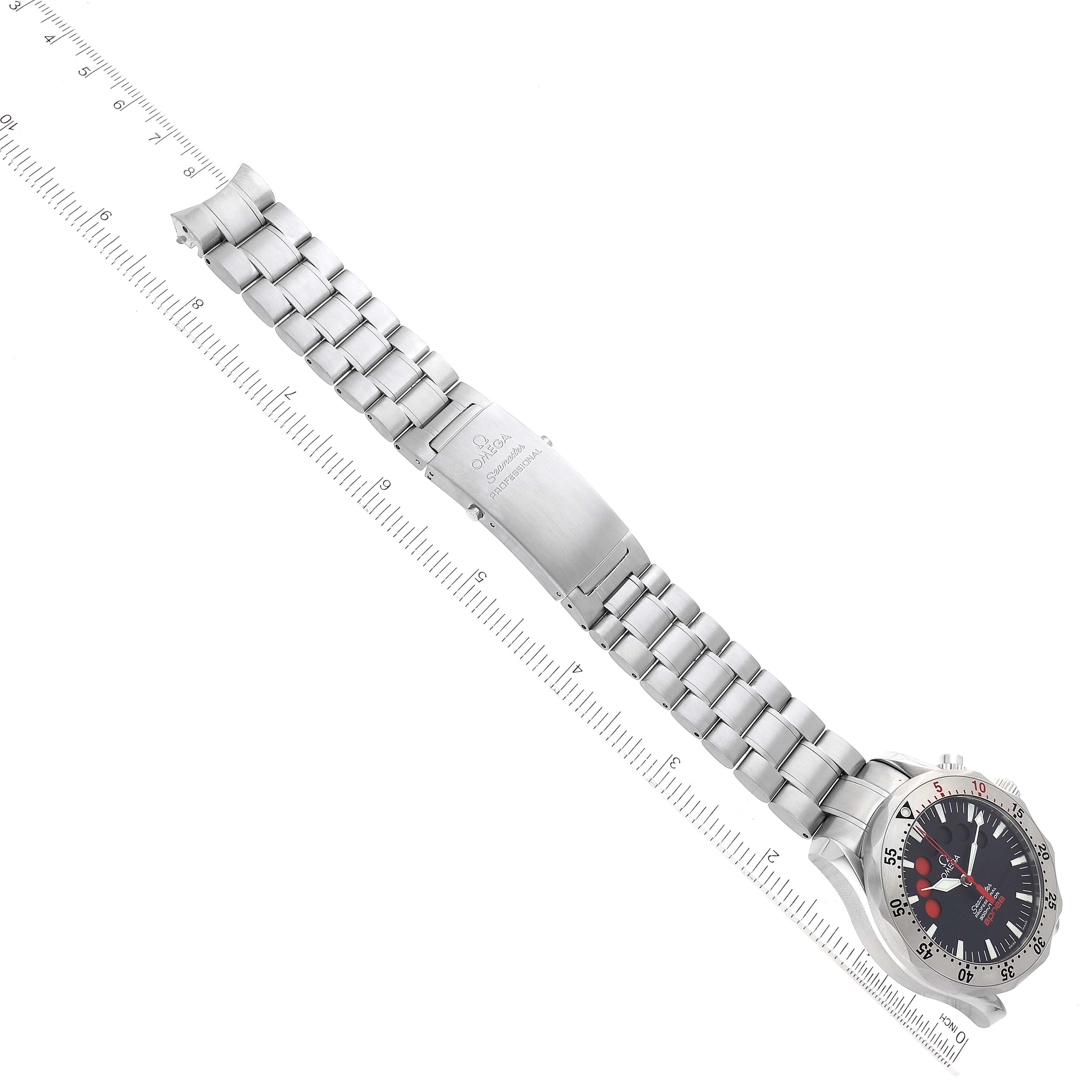 The image shows the Omega Seamaster 2595.50.00 Men's Stainless Steel Black Dial 2595.50.00 Men's Stainless Steel Black Dial watch laid flat, displaying the full length of the band and partially the dial, with a ruler alongside.