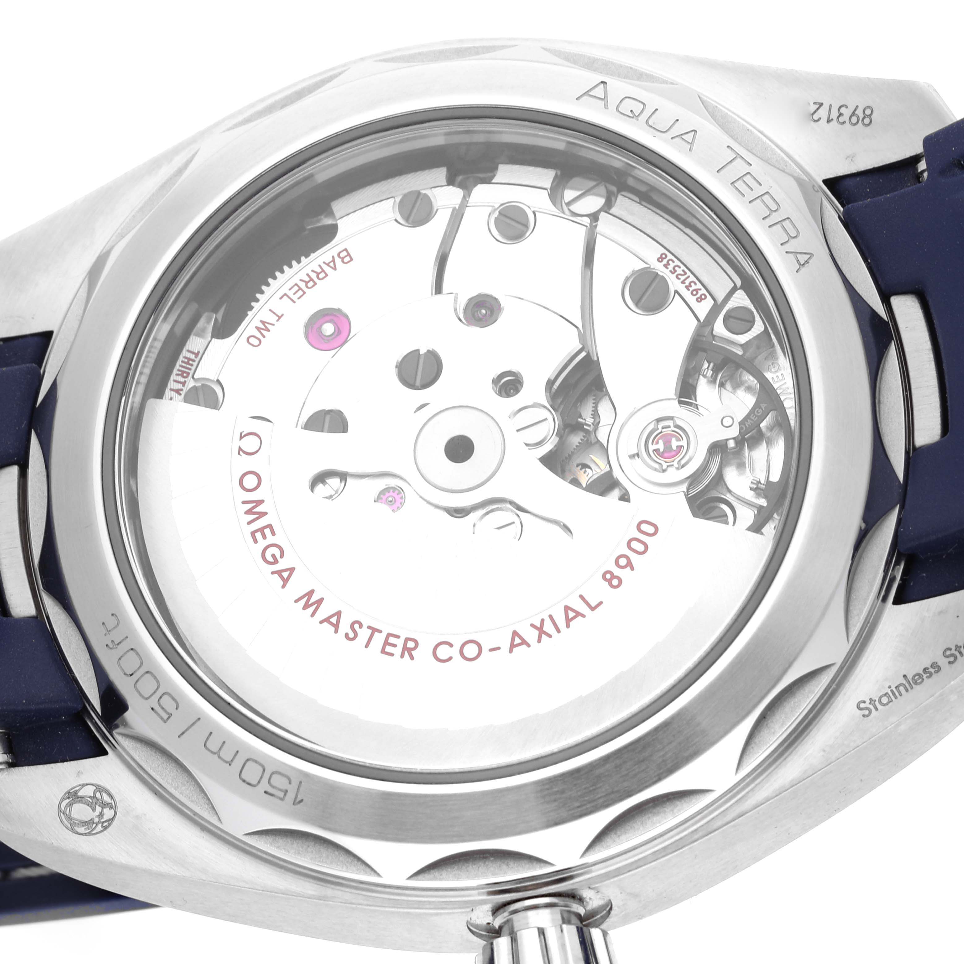 The image shows the back view of the Omega Aqua Terra 220.12.41.21.06.001 Men
s Stainless Steel Grey Dial 220.12.41.21.06.001 Men
s Stainless Steel Grey Dial watch, featuring its visible internal mechanics and the brand
s inscriptions.