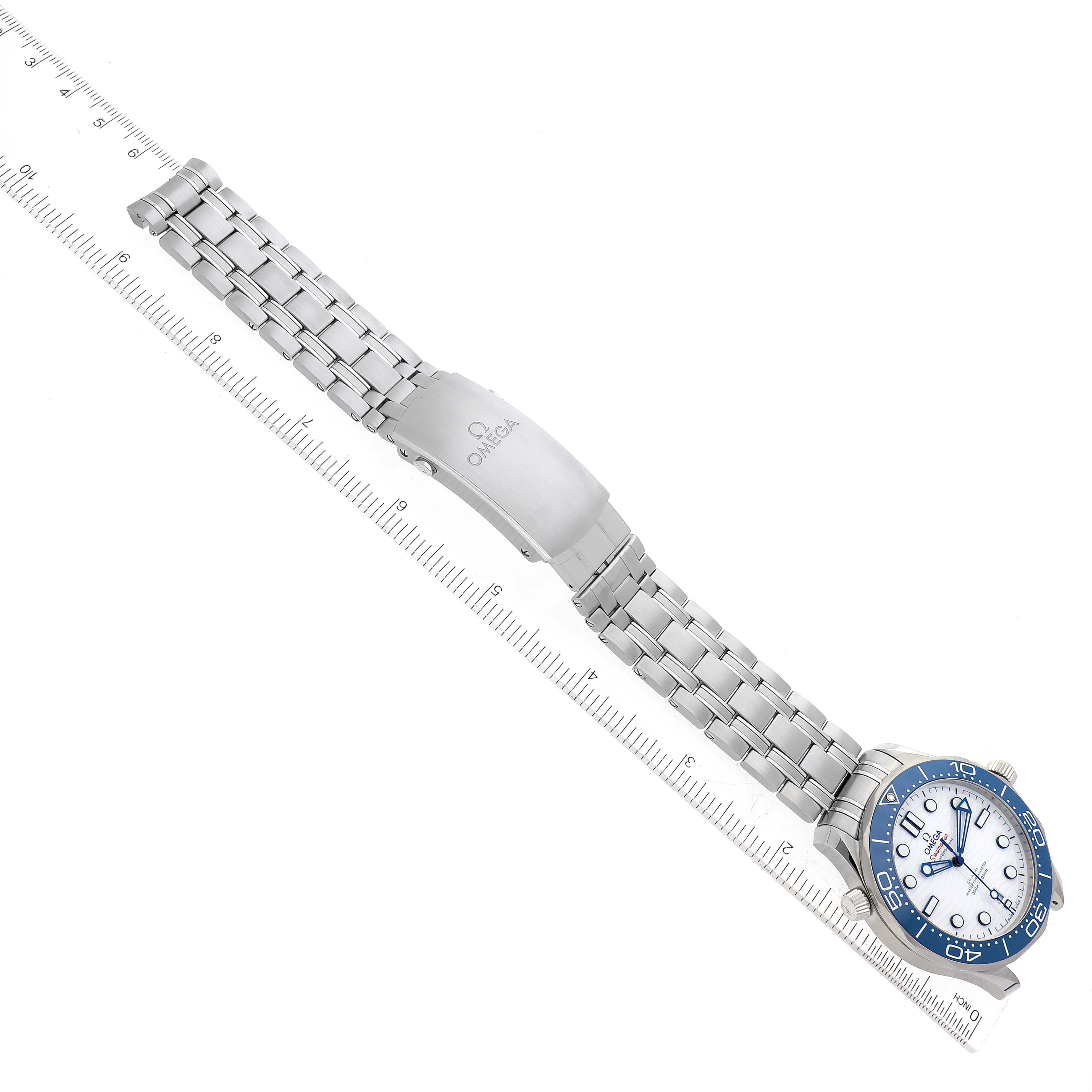 The Omega Seamaster 522.30.42.20.04.001 Men
s Stainless Steel White Dial 522.30.42.20.04.001 Men
s Stainless Steel White Dial watch is shown from above, displaying its face, bezel, bracelet, and clasp, alongside a ruler for scale.