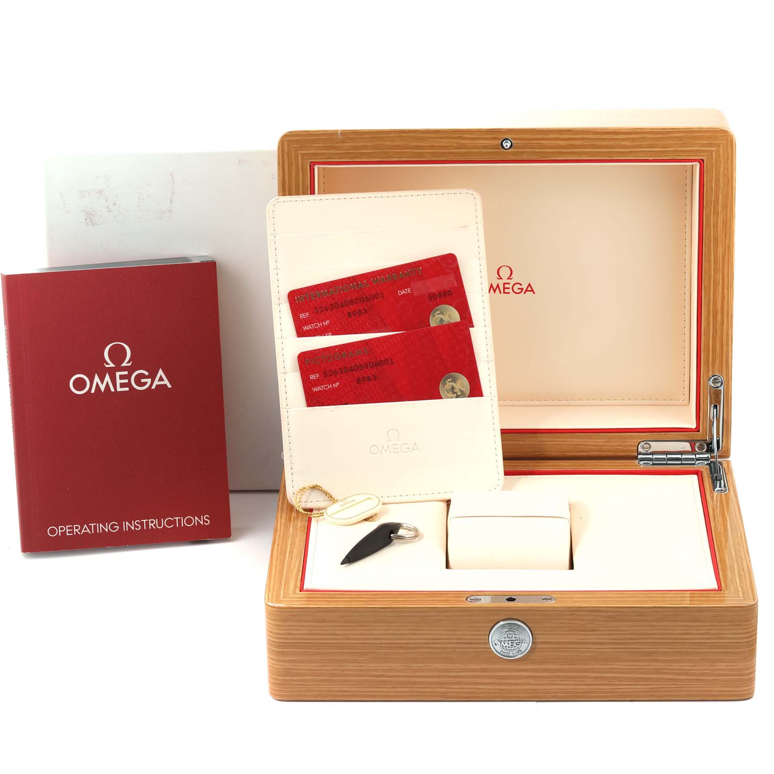 The image shows the packaging and accessories of an Omega Speedmaster 326.30.40.50.06.001 Men
s Stainless Steel Grey Dial 326.30.40.50.06.001 Men
s Stainless Steel Grey Dial, including cards and a manual, displayed from the front.