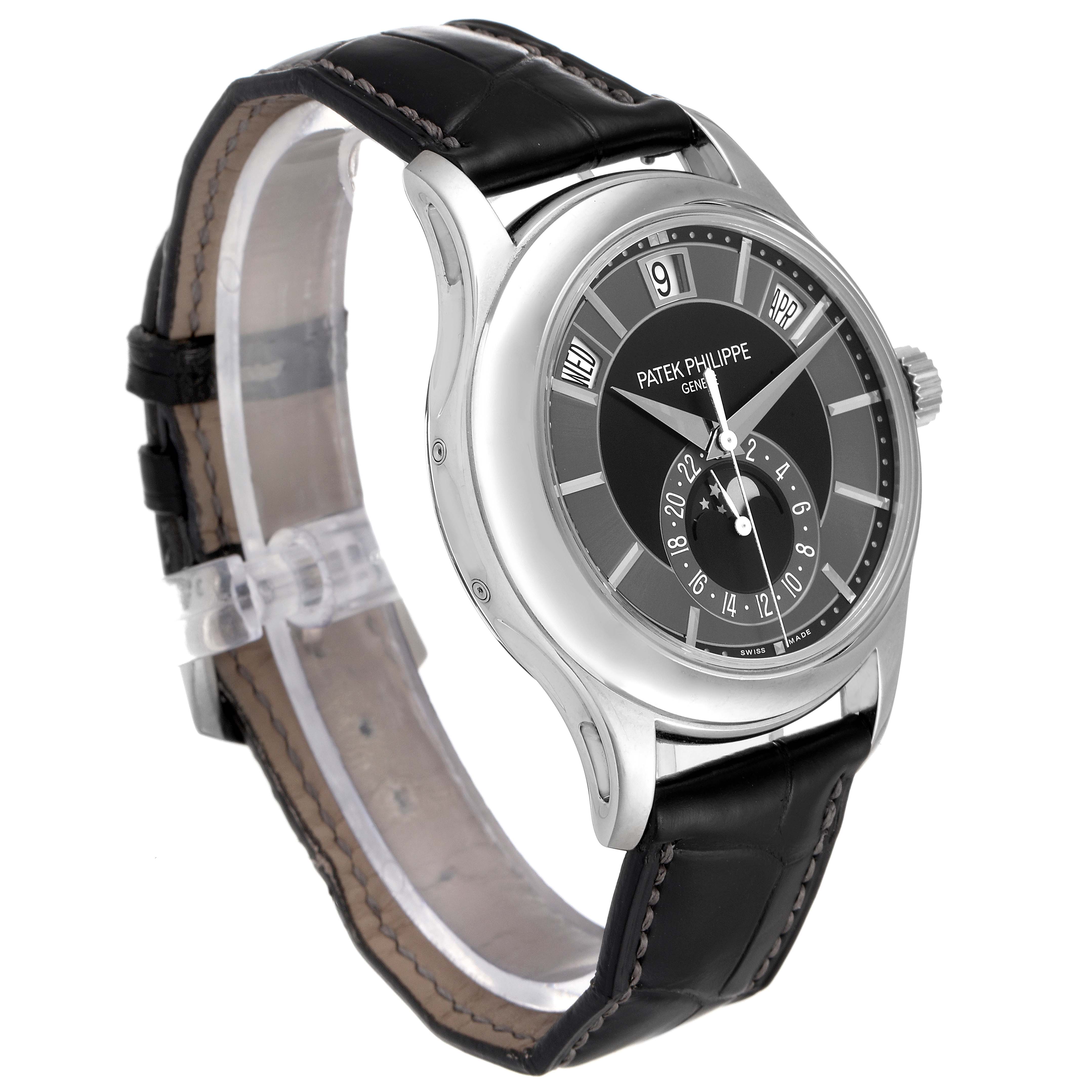 The image shows a Patek Philippe Complications 5205G - 010 Men's White Gold Grey Dial 5205G - 010 Men's White Gold Grey Dial model watch angled to display the face, case, and part of the black leather strap.