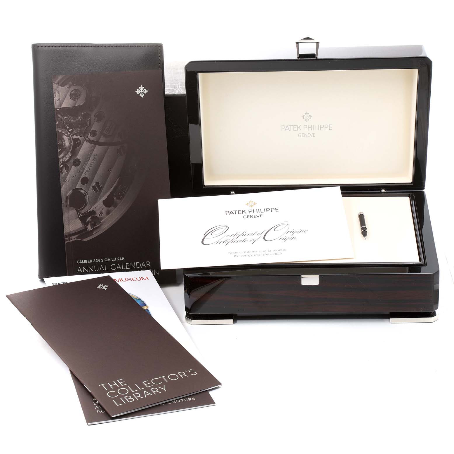 The image shows the packaging, certificate, and manuals for a Patek Philippe Complications 5205G - 010 Men's White Gold Grey Dial 5205G - 010 Men's White Gold Grey Dial watch, all arranged neatly.