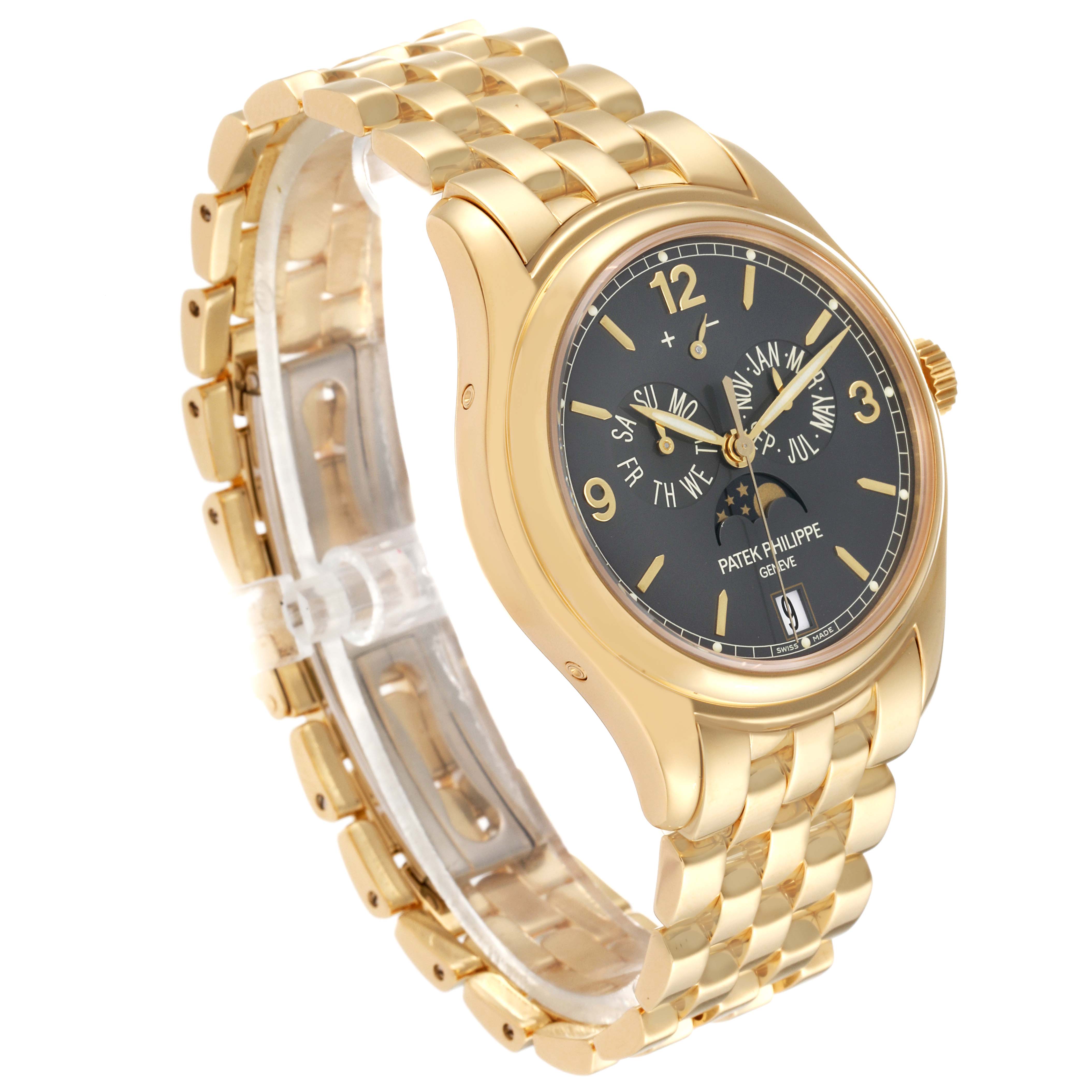 The image shows a Patek Philippe Complications 5146J-010 Men's Yellow Gold Grey Dial 5146J-010 Men's Yellow Gold Grey Dial model watch from an oblique angle, highlighting its gold case, black dial, and metal bracelet.