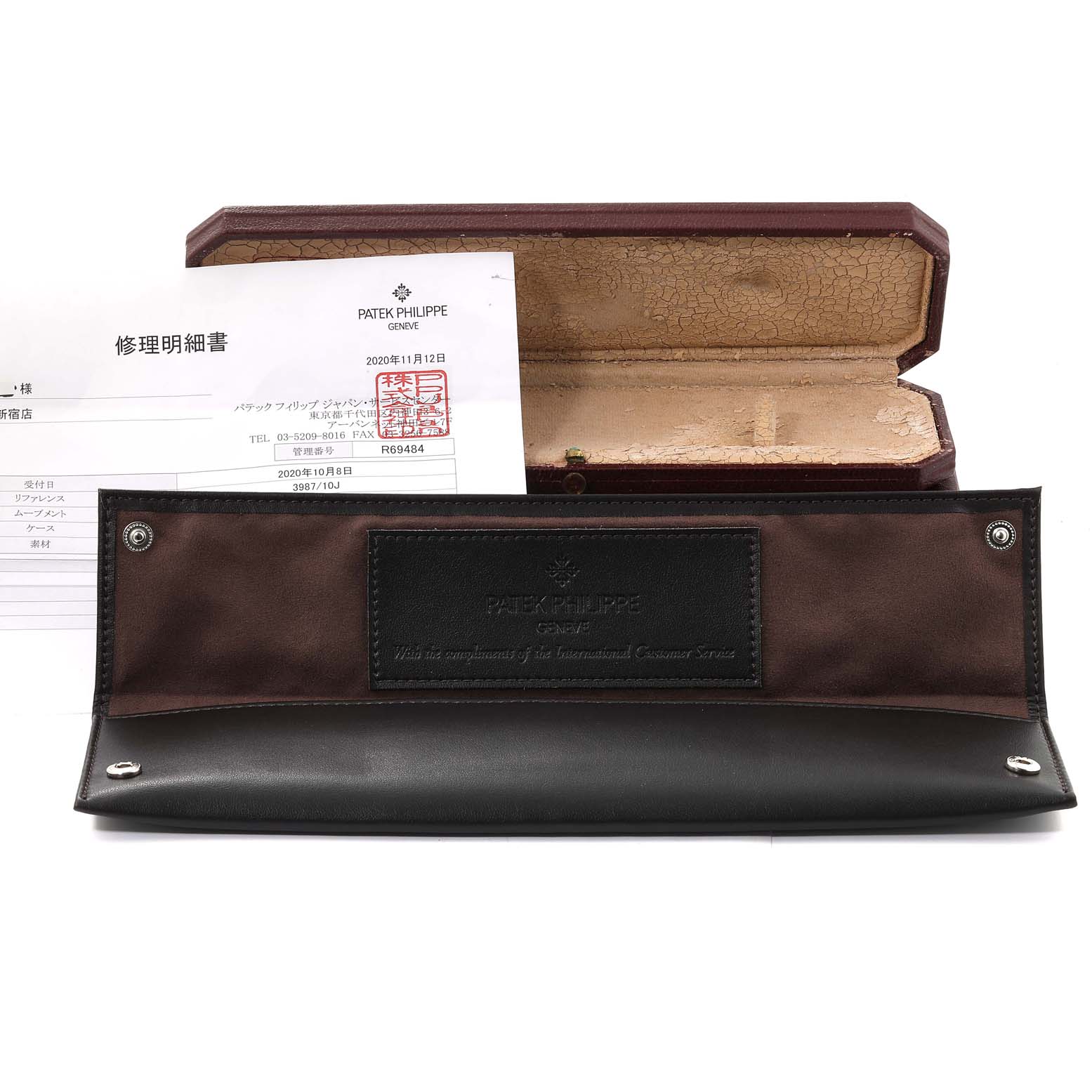 The image shows an open case, a document, and a leather holder for the Patek Philippe Golden Ellipse 3987/10J Women's Yellow Gold White Dial 3987/10J Women's Yellow Gold White Dial watch.