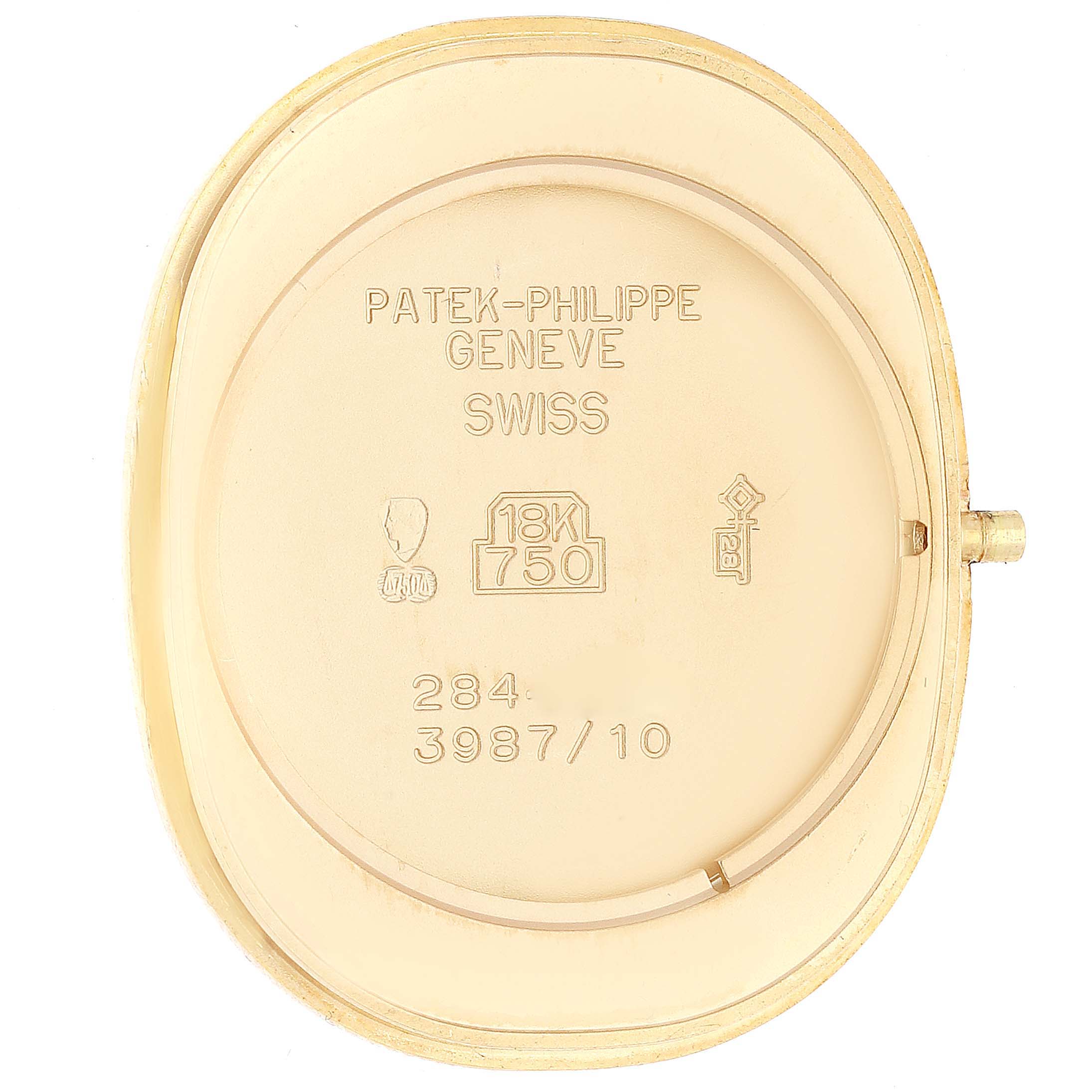 This image shows the back casing of a Patek Philippe Golden Ellipse 3987/10J Women's Yellow Gold White Dial 3987/10J Women's Yellow Gold White Dial watch, highlighting its engravings and hallmark markings.
