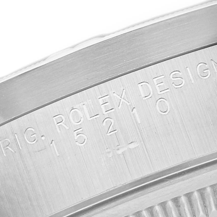 The image shows a partial side view of the Rolex Date 15210 Men's Stainless Steel Blue Dial 15210 Men's Stainless Steel Blue Dial model's engraved case, highlighting the design and serial number.