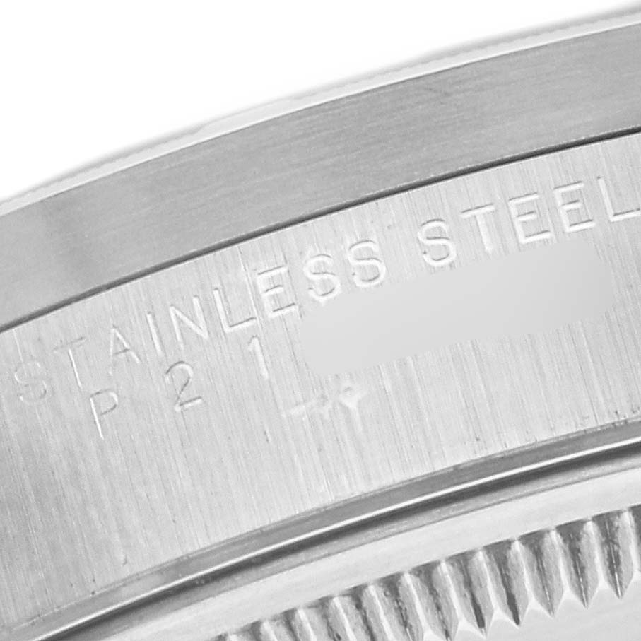 The image shows a close-up of the case back and the engravings on a Rolex Date 15210 Men's Stainless Steel Blue Dial 15210 Men's Stainless Steel Blue Dial model watch, specifically the "STAINLESS STEEL" marking.