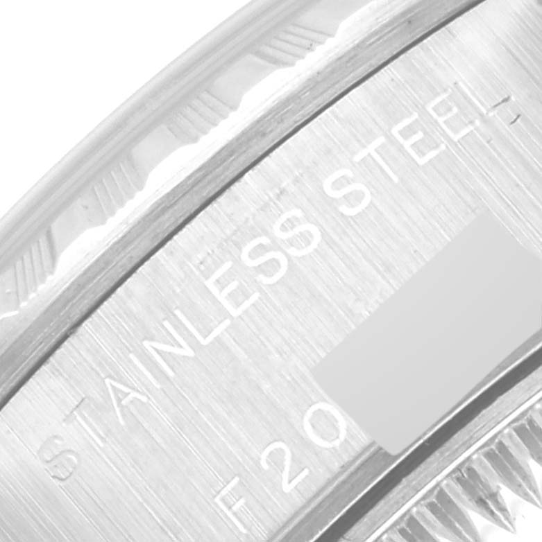 The image shows a close-up of the engraved "STAINLESS STEEL" text on the bezel of a Rolex Date 79240 Women
s Stainless Steel Silver Dial 79240 Women
s Stainless Steel Silver Dial model.