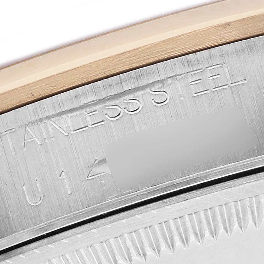 The image shows a close-up of the engraved rim on a Rolex Date 15203 Men's Steel and Gold (two tone) Champagne Dial 15203 Men's Steel and Gold (two tone) Champagne Dial model watch, highlighting "STAINLESS STEEL."
