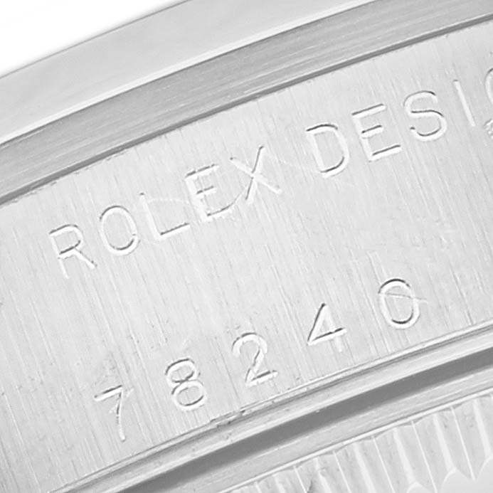 The image shows a close-up of the case back engraving on a Rolex Mid-Size 78240 Women
s Stainless Steel White Dial 78240 Women
s Stainless Steel White Dial watch, displaying the model number and "Rolex Design" text.