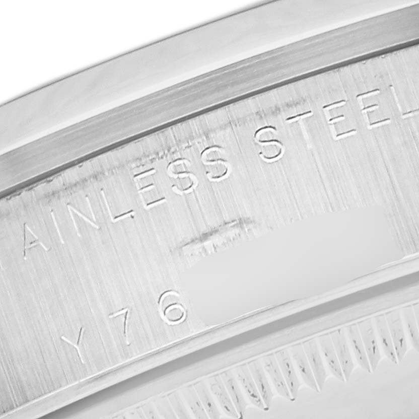 The image shows a close-up of the side casing with "STAINLESS STEEL" engraving of a Mid-Size Rolex watch.