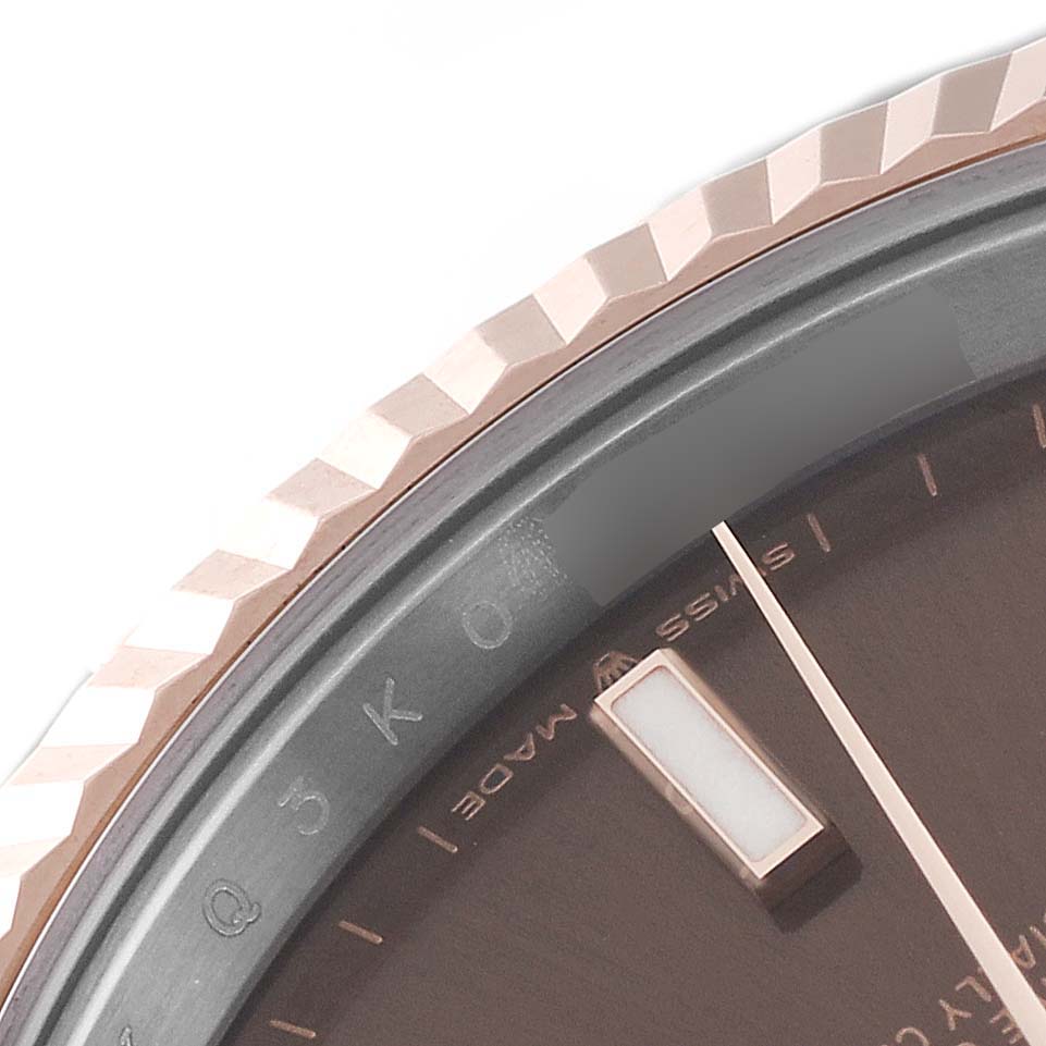 This is a close-up of the Rolex Datejust 41 126331 Men's Steel and Gold (two tone) Brown Dial 126331 Men's Steel and Gold (two tone) Brown Dial model showing the fluted bezel, part of the dial, and an hour marker.