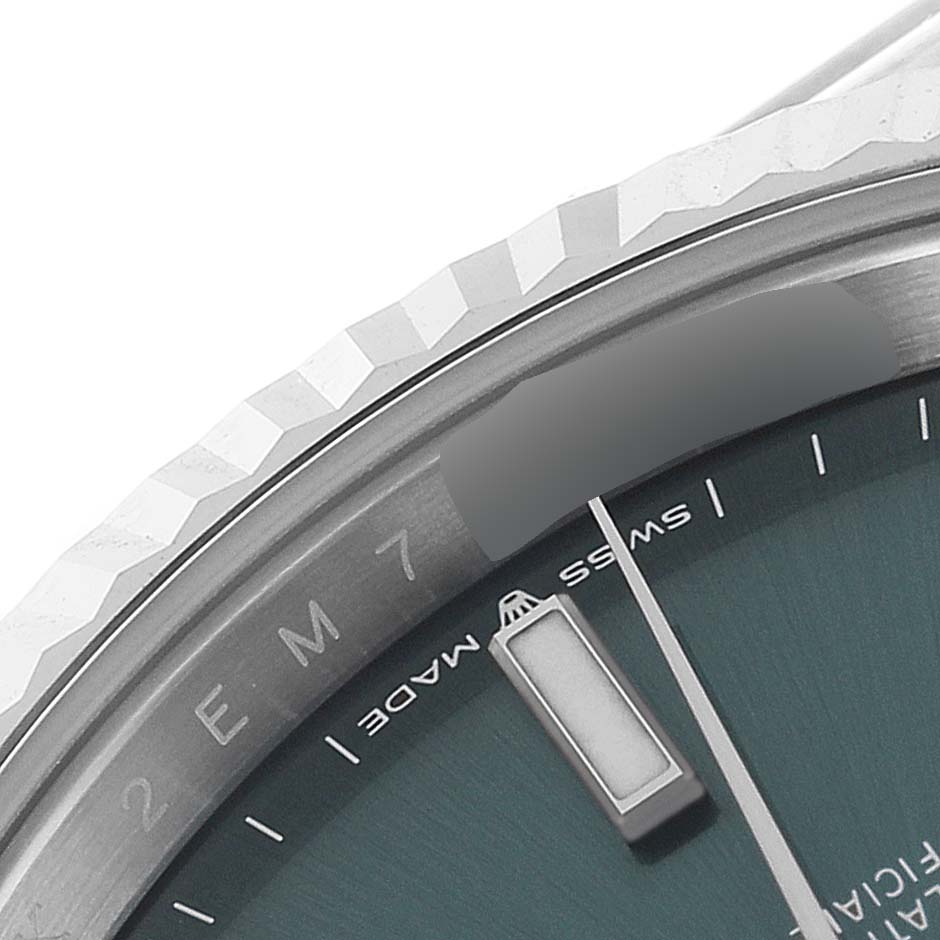 This image shows a close-up of the dial
s edge, including the fluted bezel and part of the minute hand of the Rolex Datejust 41 126334 Men
s Stainless Steel Green Dial 126334 Men
s Stainless Steel Green Dial.