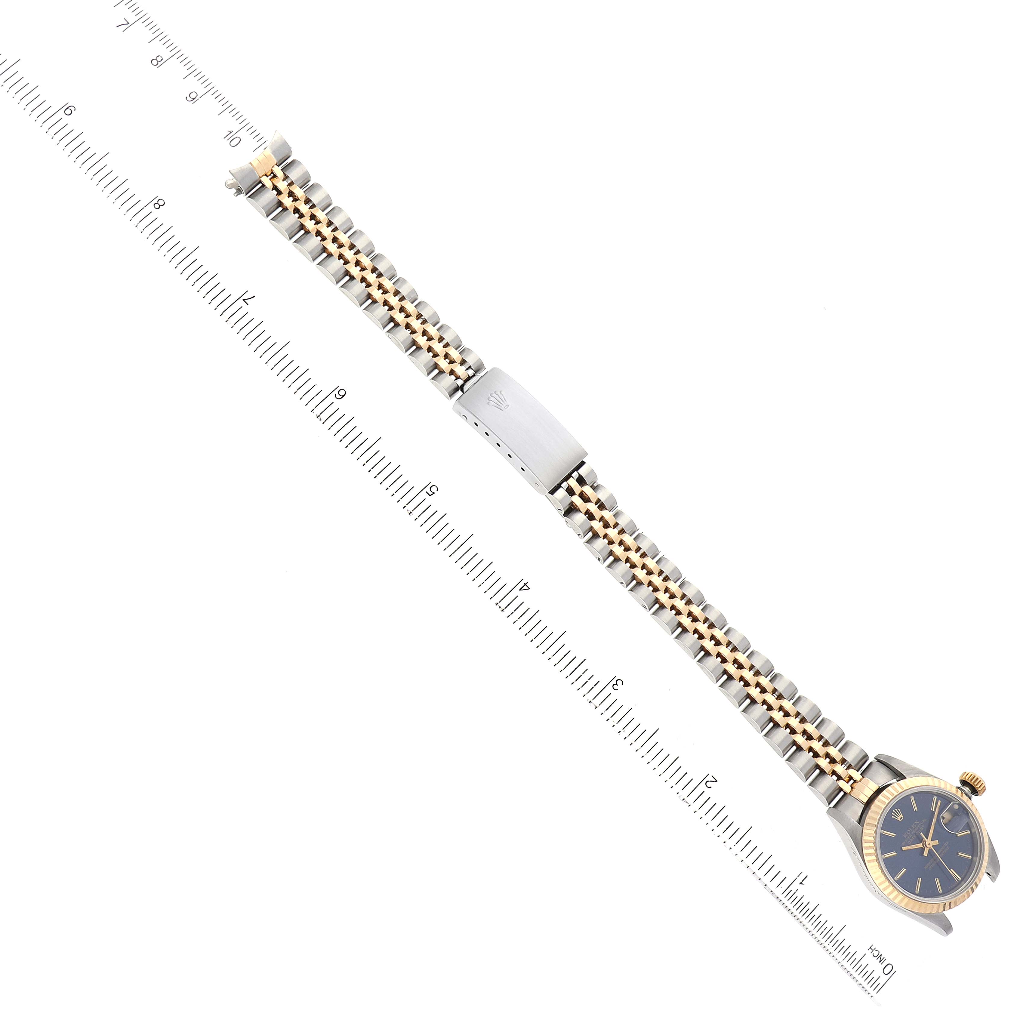 This image shows an overhead view of a Rolex Datejust 69173 Women's Steel and Gold (two tone) Blue Dial 69173 Women's Steel and Gold (two tone) Blue Dial watch, displaying the bracelet, clasp, and part of the watch face with a ruler for scale.