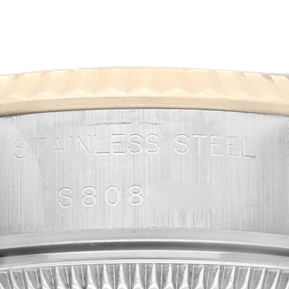 The image shows a close-up of the stainless steel casing and bezel detail of a Rolex Datejust 69173 Women's Steel and Gold (two tone) Blue Dial 69173 Women's Steel and Gold (two tone) Blue Dial watch with visible engraving.