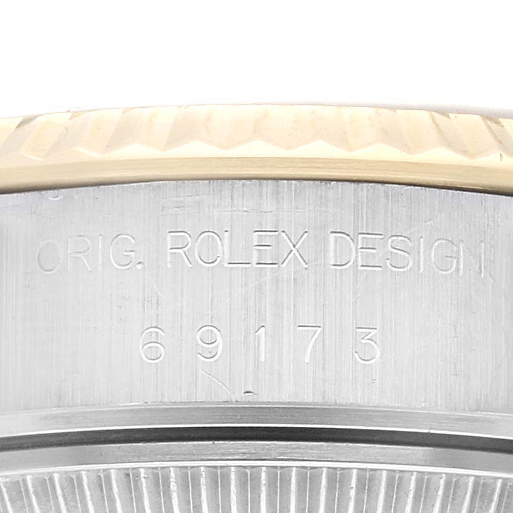 The image shows an angled close-up of the Rolex Datejust 69173 Women's Steel and Gold (two tone) Champagne Dial 69173 Women's Steel and Gold (two tone) Champagne Dial case side with model number engraving.