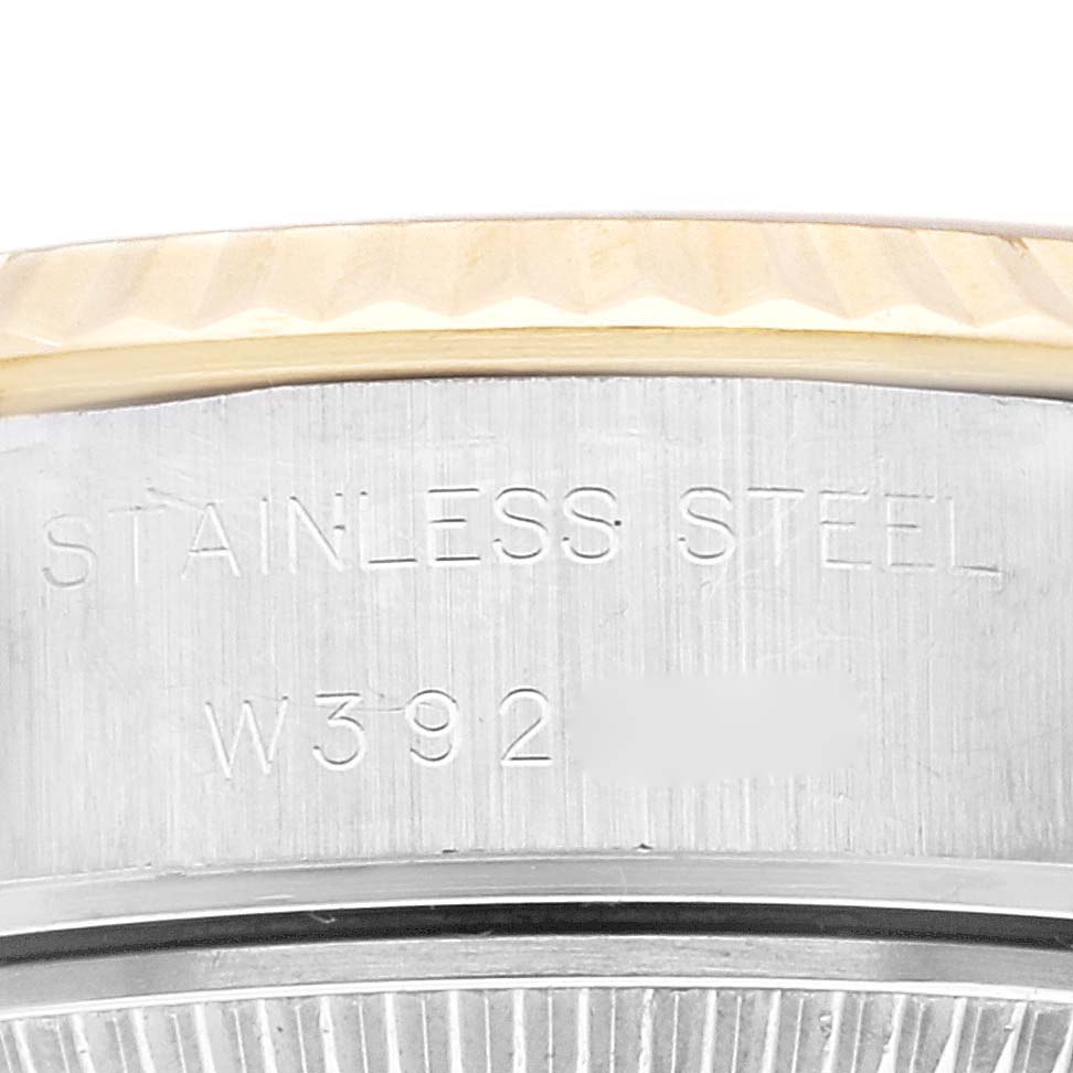The image shows the side engraved with "Stainless Steel" and part of the serial number on a Rolex Datejust 69173 Women's Steel and Gold (two tone) Champagne Dial 69173 Women's Steel and Gold (two tone) Champagne Dial watch.