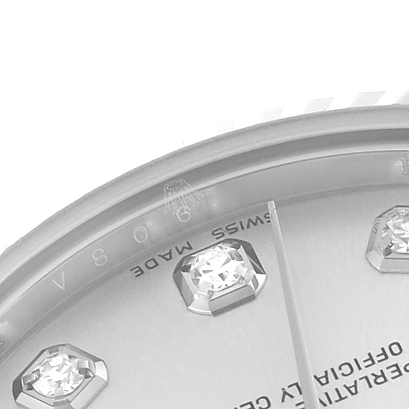 This image shows a close-up view of a Rolex Mid-Size 178274 Women
s Stainless Steel Silver Dial 178274 Women
s Stainless Steel Silver Dial watch dial, featuring diamond hour markers and part of the "Swiss Made" inscription.