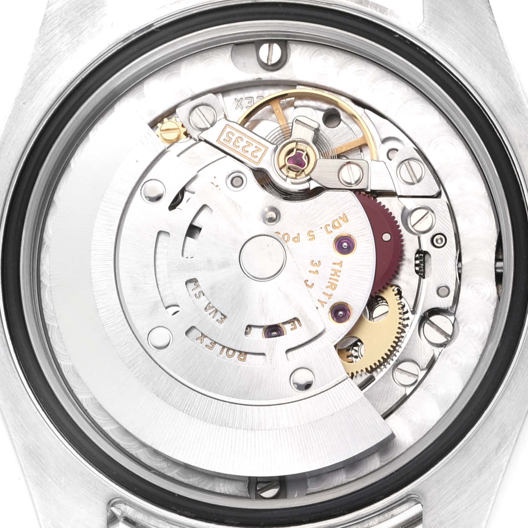The image shows the internal mechanism of a Mid-Size Rolex watch from a rear-view angle, focusing on the movement components.