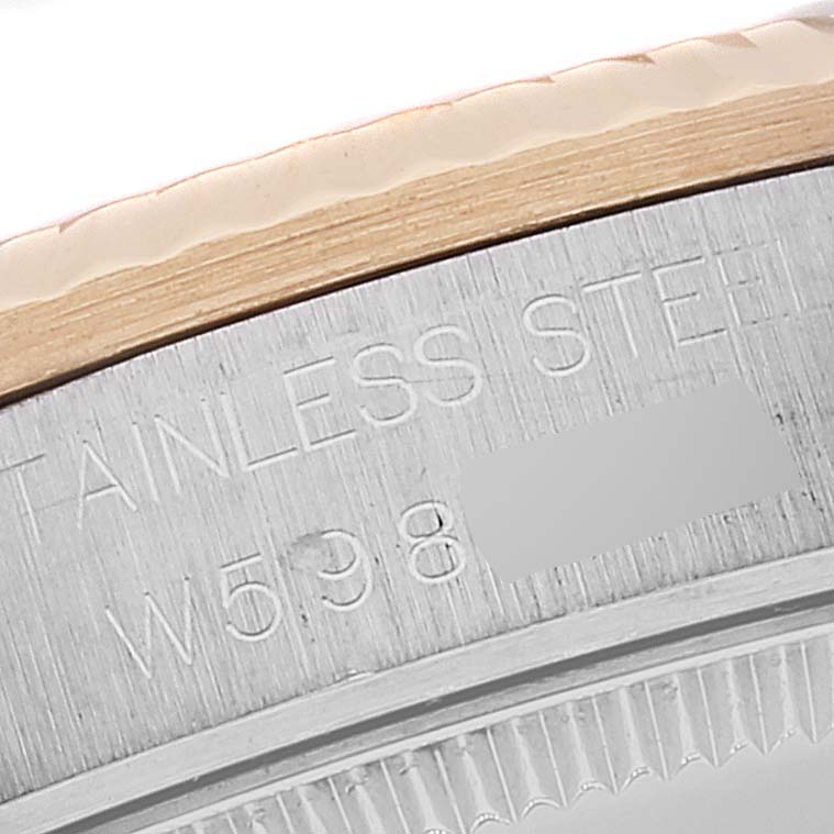 The image shows a close-up of the case back of a Rolex Mid-Size 68273 Women's Steel and Gold (two tone) Champagne Dial 68273 Women's Steel and Gold (two tone) Champagne Dial model, highlighting the engraved stainless steel marking and serial number.