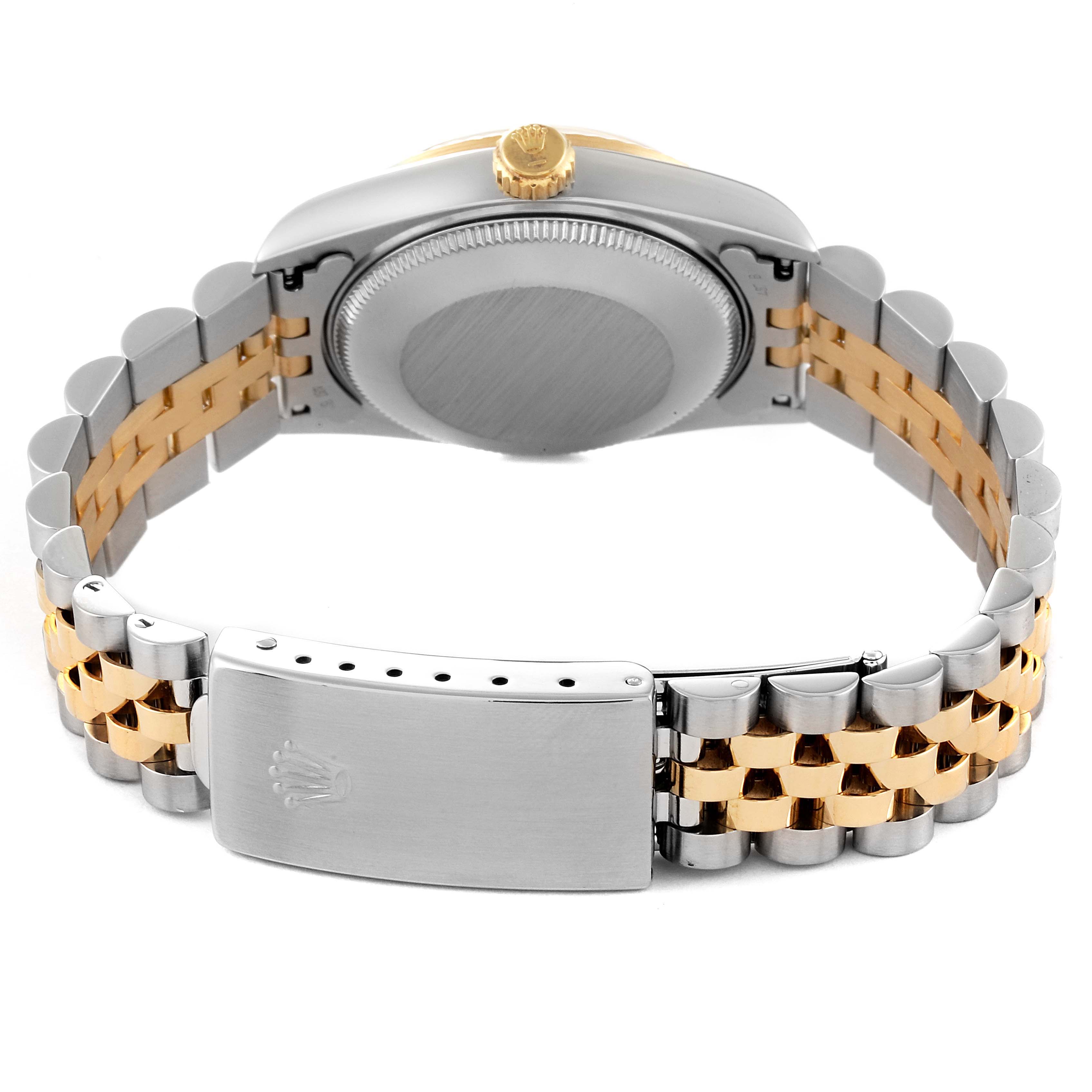 This Rolex Mid-Size 68273 Women's Steel and Gold (two tone) Champagne Dial 68273 Women's Steel and Gold (two tone) Champagne Dial watch is shown from the back, highlighting its case, crown, and two-tone bracelet with a clasp.