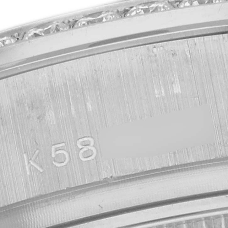 This image shows a close-up of the engraved inner bezel of a Rolex President 179159 Women's White Gold Mother of Pearl Dial 179159 Women's White Gold Mother of Pearl Dial watch, including part of the serial number and diamond detailing.