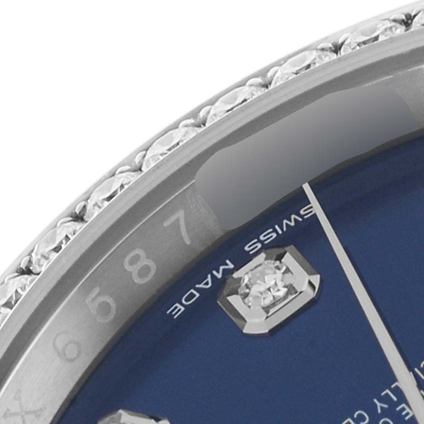 This close-up of the Rolex Datejust 116244 Men's Stainless Steel Blue Dial 116244 Men's Stainless Steel Blue Dial watch shows part of the bezel with diamonds, the blue dial, and the "Swiss Made" label.