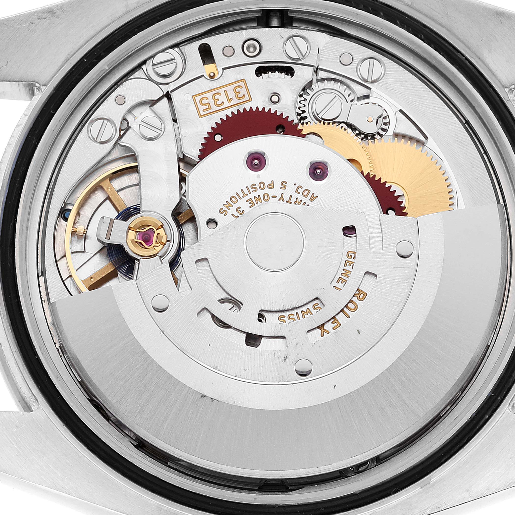 This image shows the movement mechanism of a Rolex Datejust 116244 Men's Stainless Steel Blue Dial 116244 Men's Stainless Steel Blue Dial watch from a rear angle, revealing gears and parts.