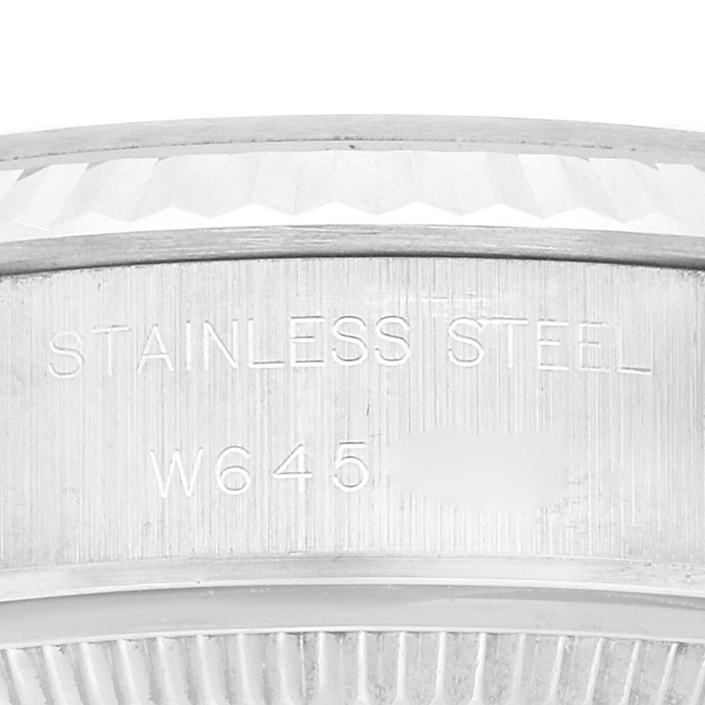 The image shows the side of the case and stamped details on a Rolex Datejust 69174 Women's Stainless Steel Blue Dial 69174 Women's Stainless Steel Blue Dial watch, focusing on the serial number and stainless steel engraving.