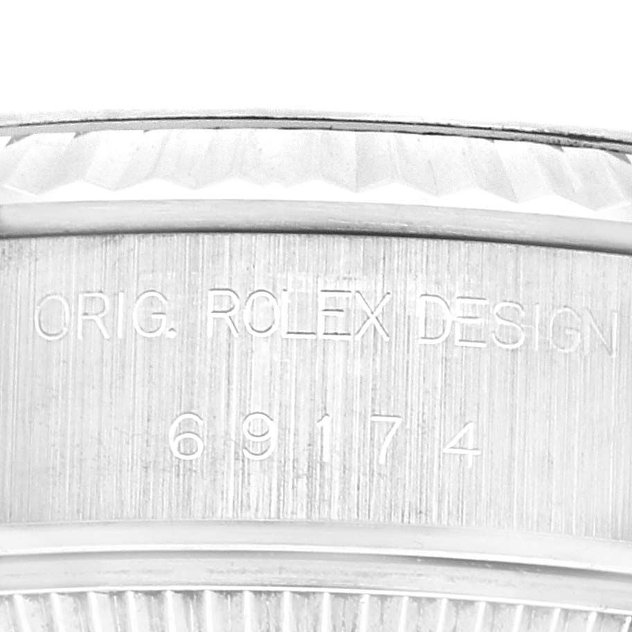 This close-up image shows part of the bezel and the engraved design number on a Rolex Datejust 69174 Women's Stainless Steel Blue Dial 69174 Women's Stainless Steel Blue Dial watch.