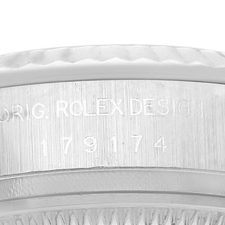 This image shows a close-up of the case side of a Rolex Datejust 179174 Women's Stainless Steel Blue Dial 179174 Women's Stainless Steel Blue Dial, featuring the model number and "Rolex Design" engraving.