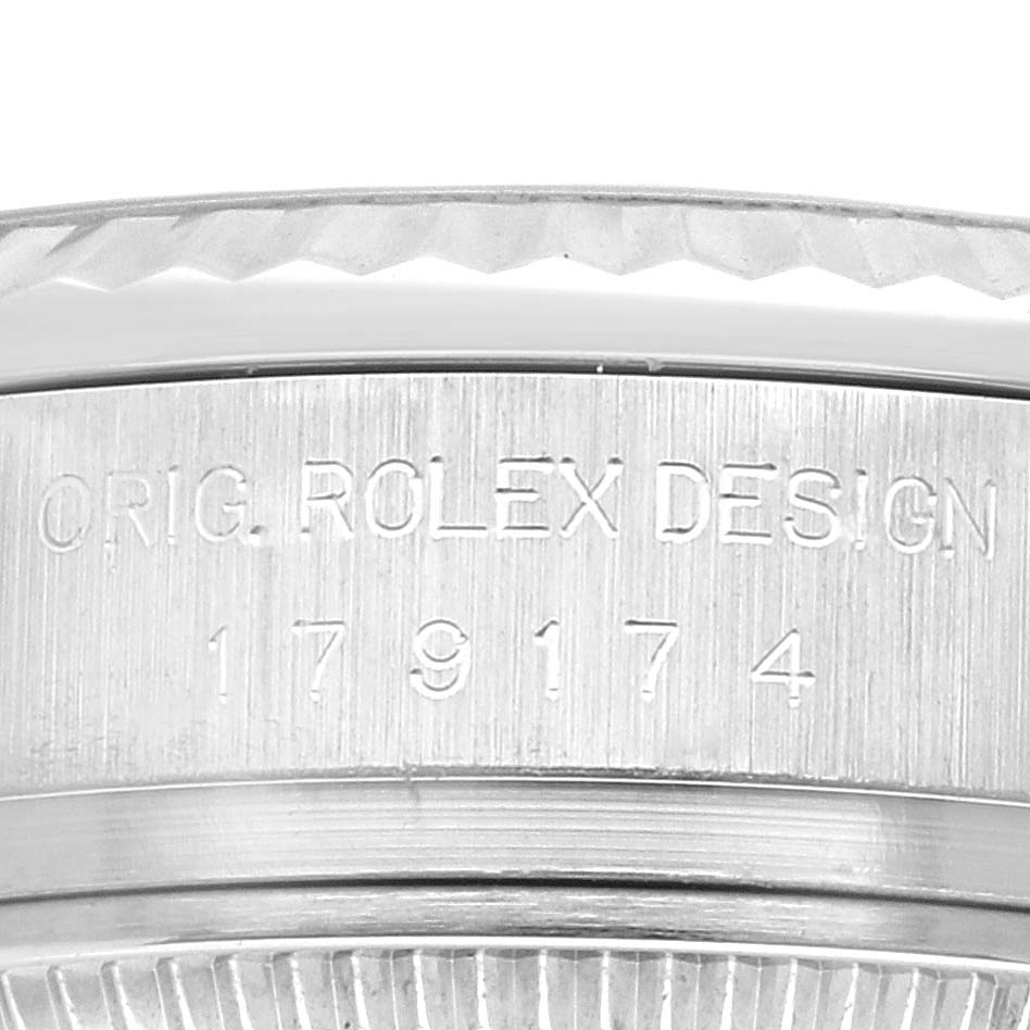 The image shows a close-up of the engraved case side of a Rolex Datejust 179174 Women's Stainless Steel Silver Dial 179174 Women's Stainless Steel Silver Dial watch, highlighting the model number and design inscription.