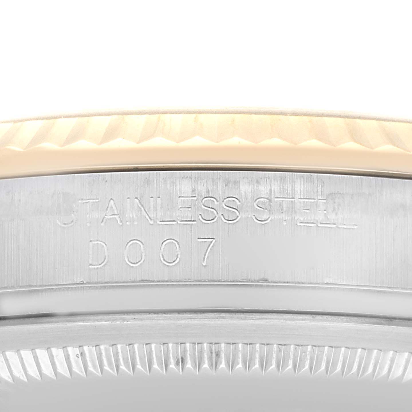 This image shows a close-up of the side engraving on a Rolex Datejust 116233 Men's Steel and Gold (two tone) Champagne Dial 116233 Men's Steel and Gold (two tone) Champagne Dial, focusing on "STAINLESS STEEL D007."