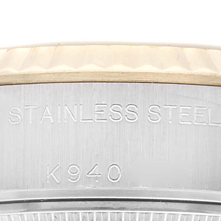 The image shows a close-up of the side of a Rolex Datejust 79173G Women's Steel and Gold (two tone) Black Dial 79173G Women's Steel and Gold (two tone) Black Dial watch, highlighting the bezel and part of the stainless steel case with engravings.