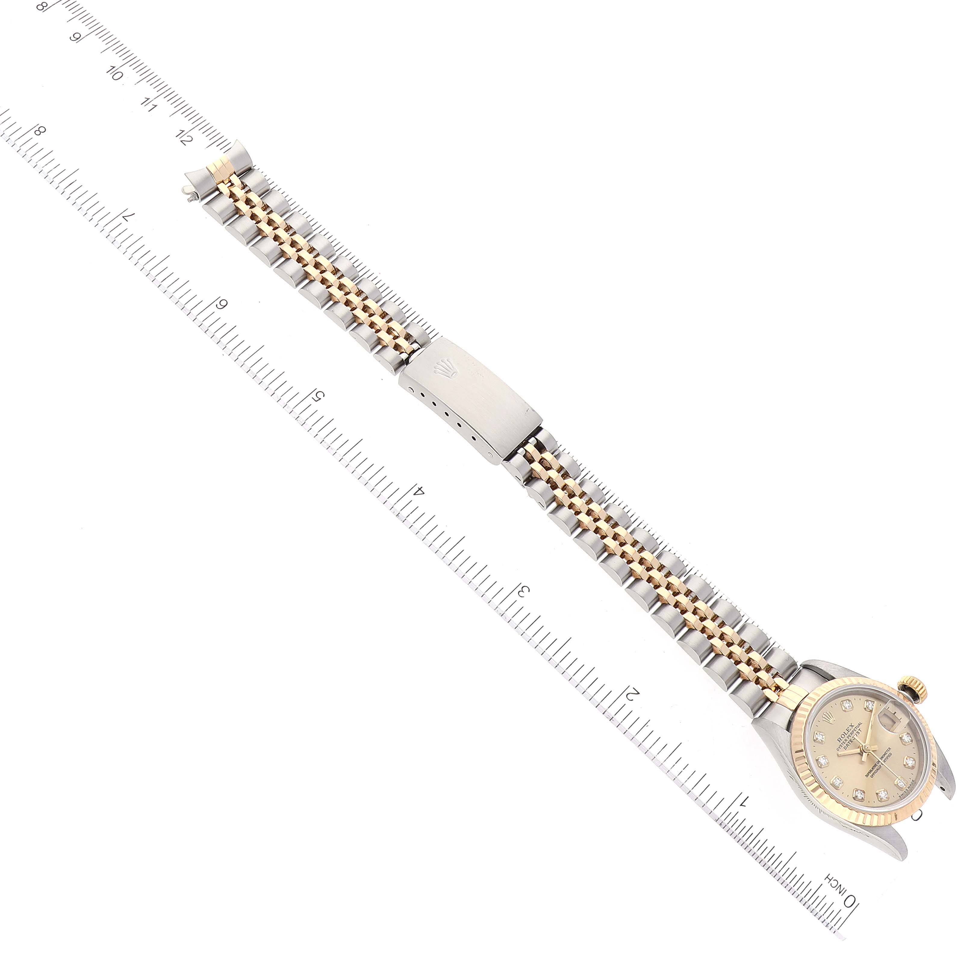 The image shows a Rolex Datejust 69173 Women's Steel and Gold (two tone) Champagne Dial 69173 Women's Steel and Gold (two tone) Champagne Dial watch laid flat with a ruler for measurement, highlighting the bracelet and clasp.