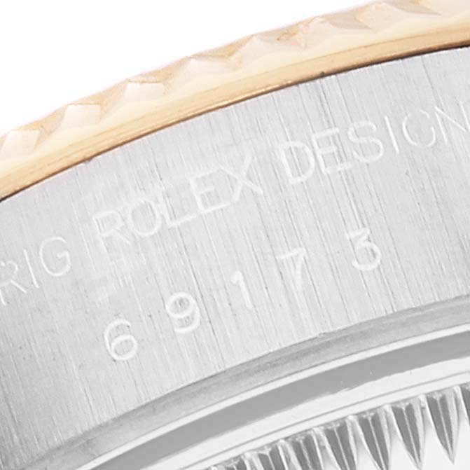 This image shows a close-up of the case back and bezel of a Rolex Datejust 69173 Women's Steel and Gold (two tone) Champagne Dial 69173 Women's Steel and Gold (two tone) Champagne Dial watch.