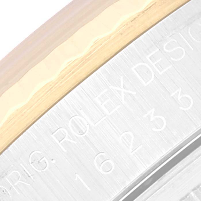 This image shows a close-up of the bezel and part of the casing with engraved text of a Rolex Datejust 16233 Men's Steel and Gold (two tone) White Dial 16233 Men's Steel and Gold (two tone) White Dial watch.
