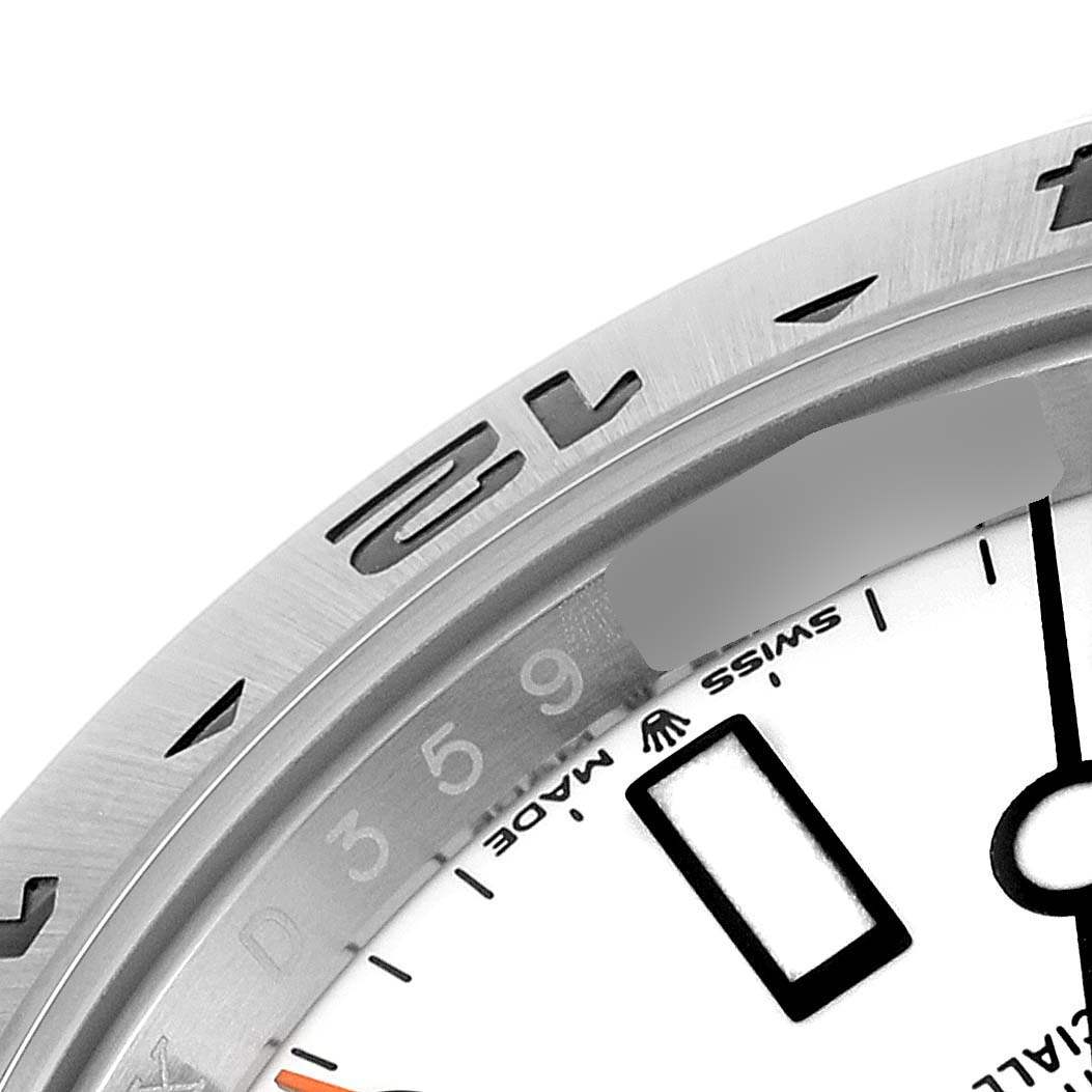 The image shows a close-up of the bezel and part of the dial of a Rolex Explorer 226570 Men
s Stainless Steel White Dial 226570 Men
s Stainless Steel White Dial watch.