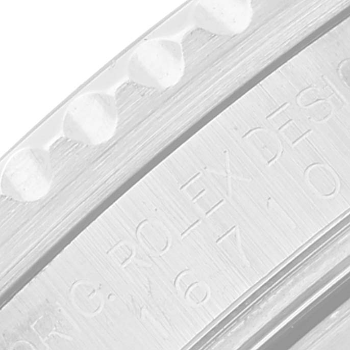 This close-up image shows the engraved bezel edge of a Rolex GMT-Master 16710 Men's Stainless Steel Black Dial 16710 Men's Stainless Steel Black Dial watch.