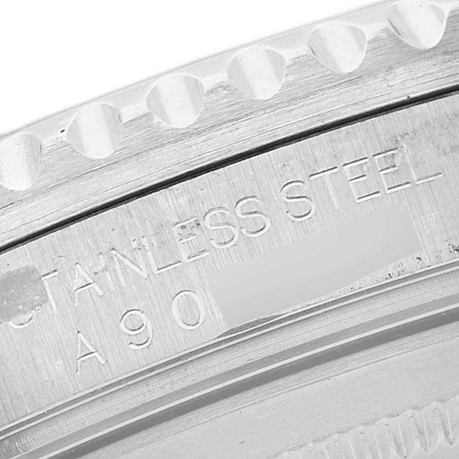 This close-up image of a Rolex GMT-Master 16710 Men's Stainless Steel Black Dial 16710 Men's Stainless Steel Black Dial watch shows the side with engraved text "STAINLESS STEEL."