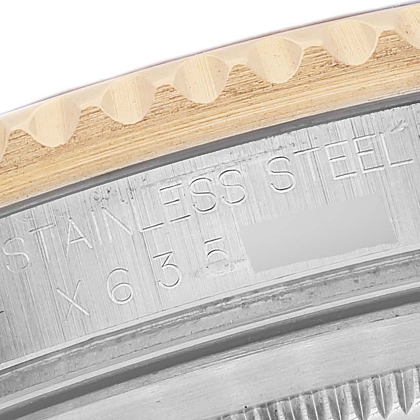 This image shows a close-up of the case back and edge of the bezel on a Rolex GMT-Master 16713 Men's Steel and Gold (two tone) Grey Dial 16713 Men's Steel and Gold (two tone) Grey Dial watch.
