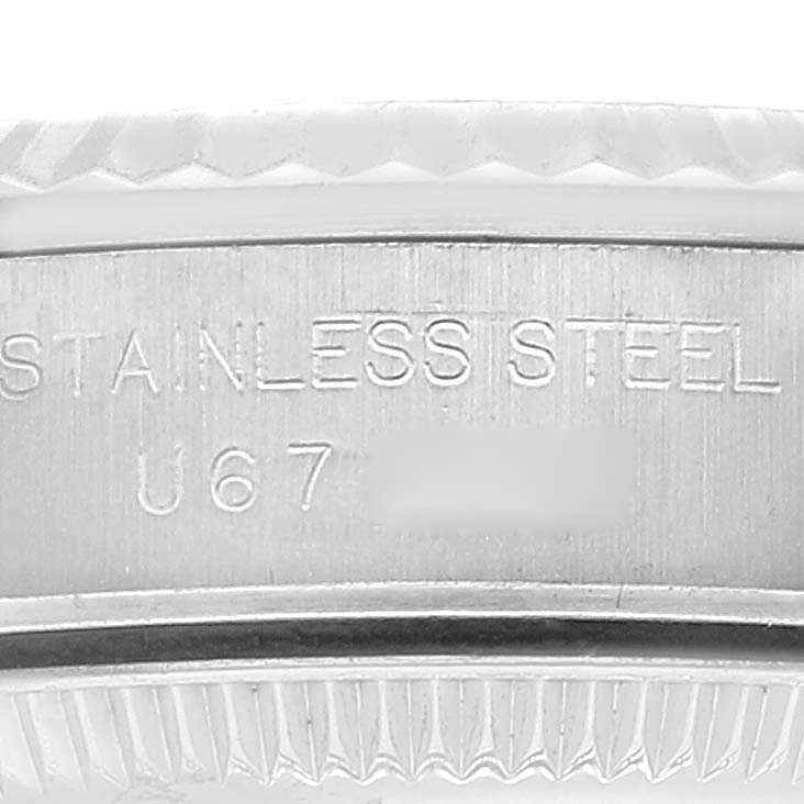 This image shows a close-up of the stainless steel case back and serial number of a Rolex Oyster Perpetual 67194 Women's Stainless Steel Silver Dial 67194 Women's Stainless Steel Silver Dial watch.